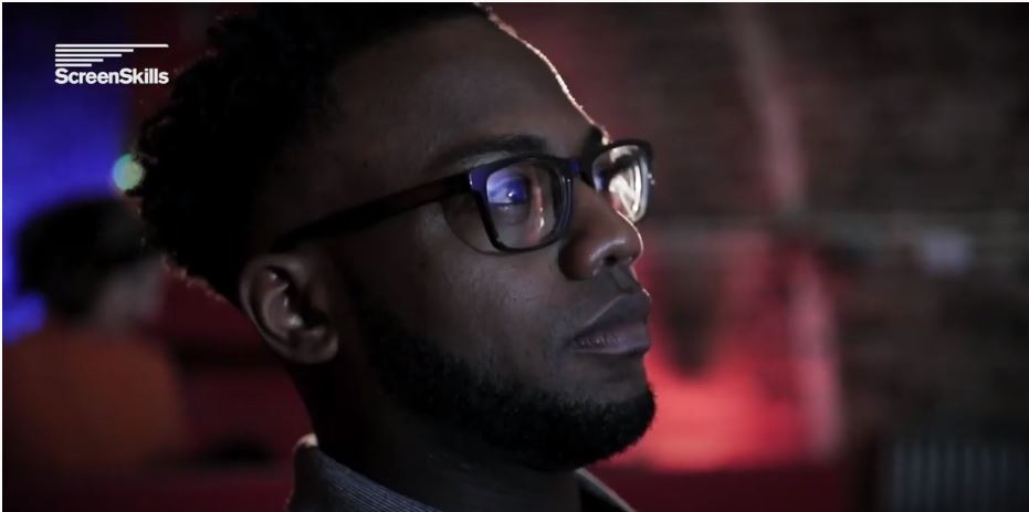 A close up of a man looking at something towards the right