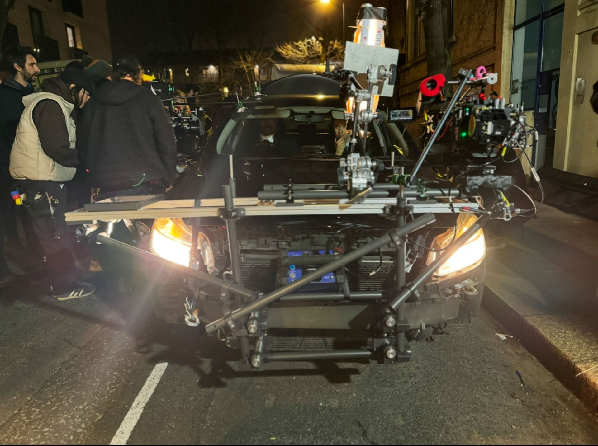 A team installing a car grip on a film shoot