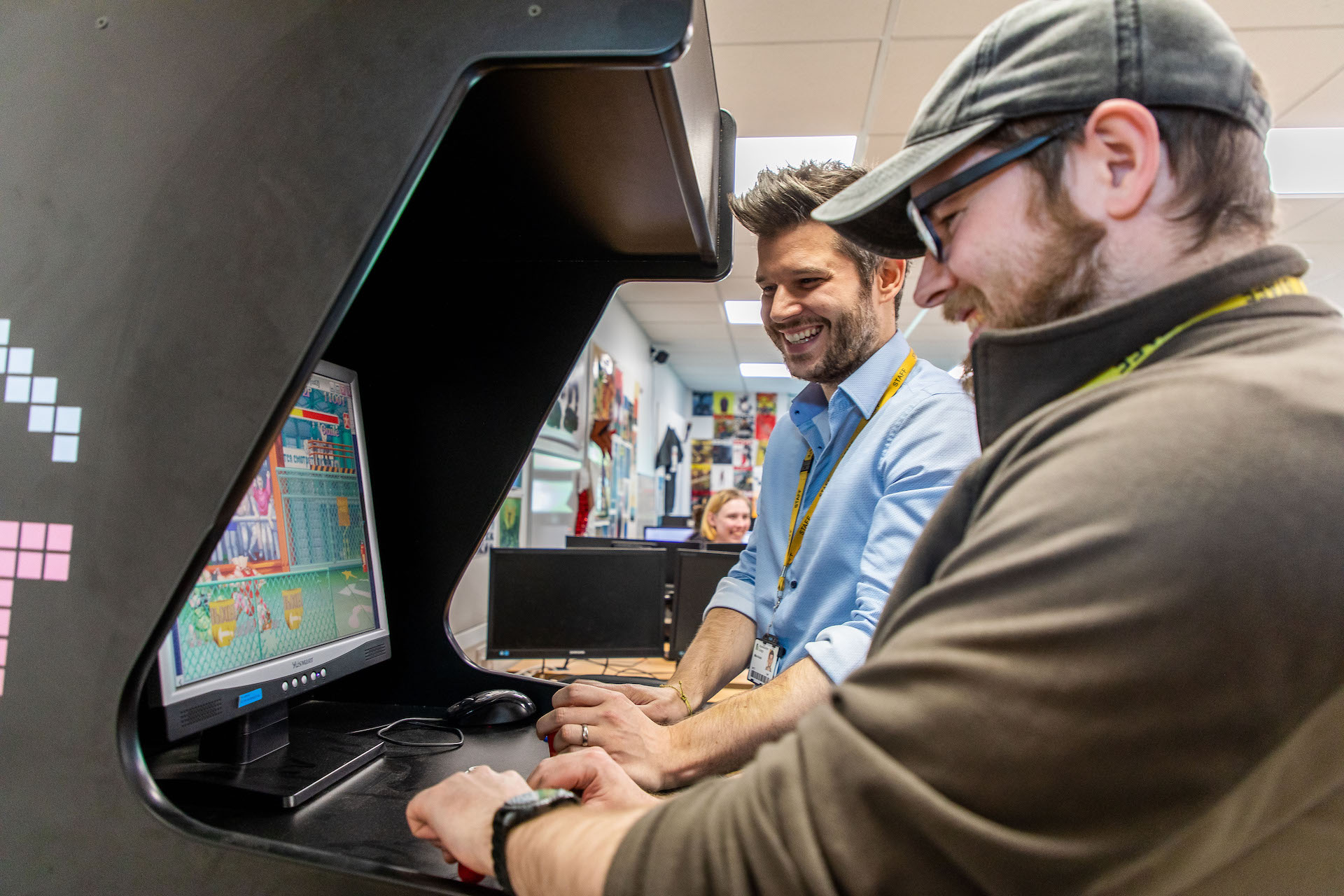 Two men gaming on an arcade machine