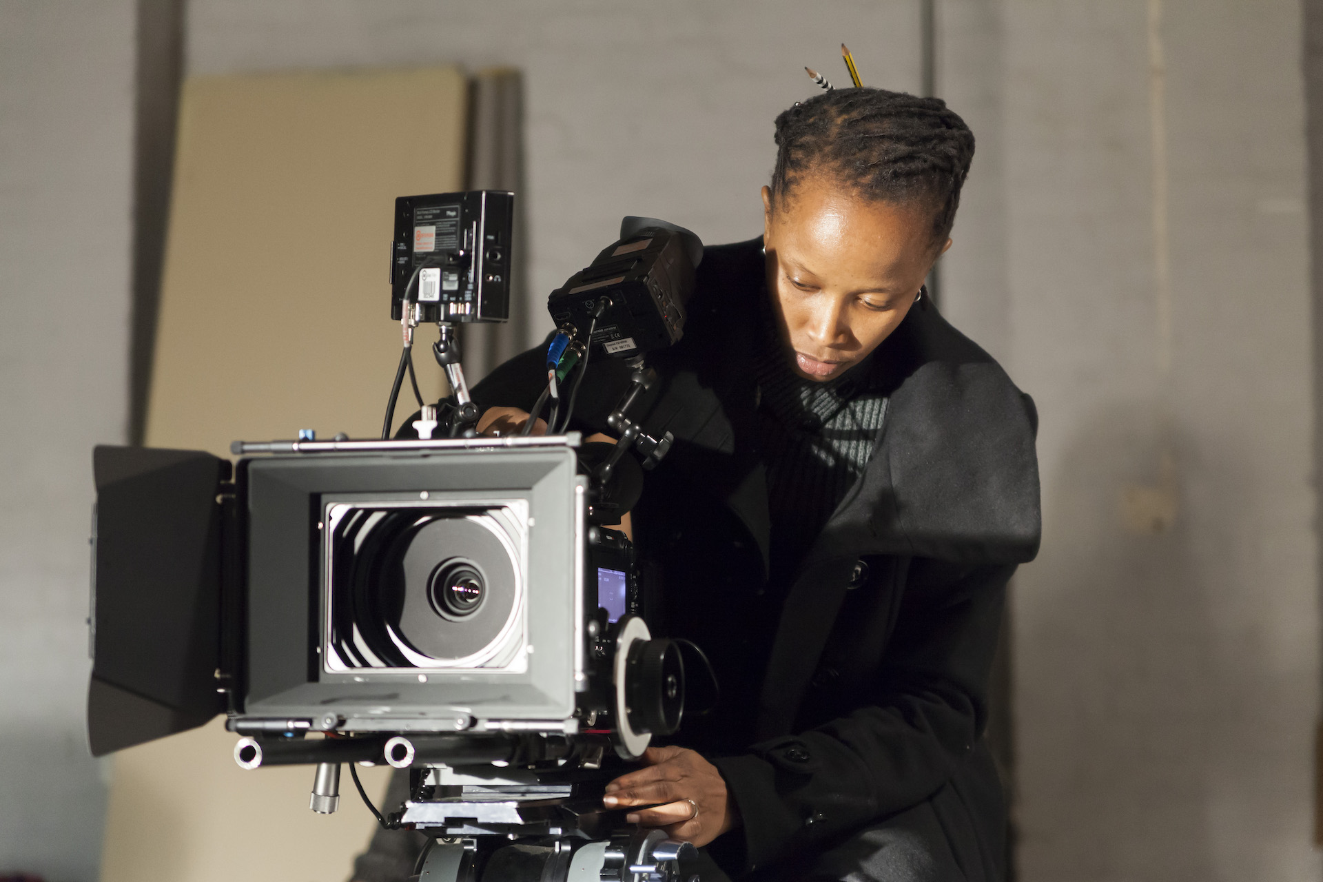 Young woman behind a camera