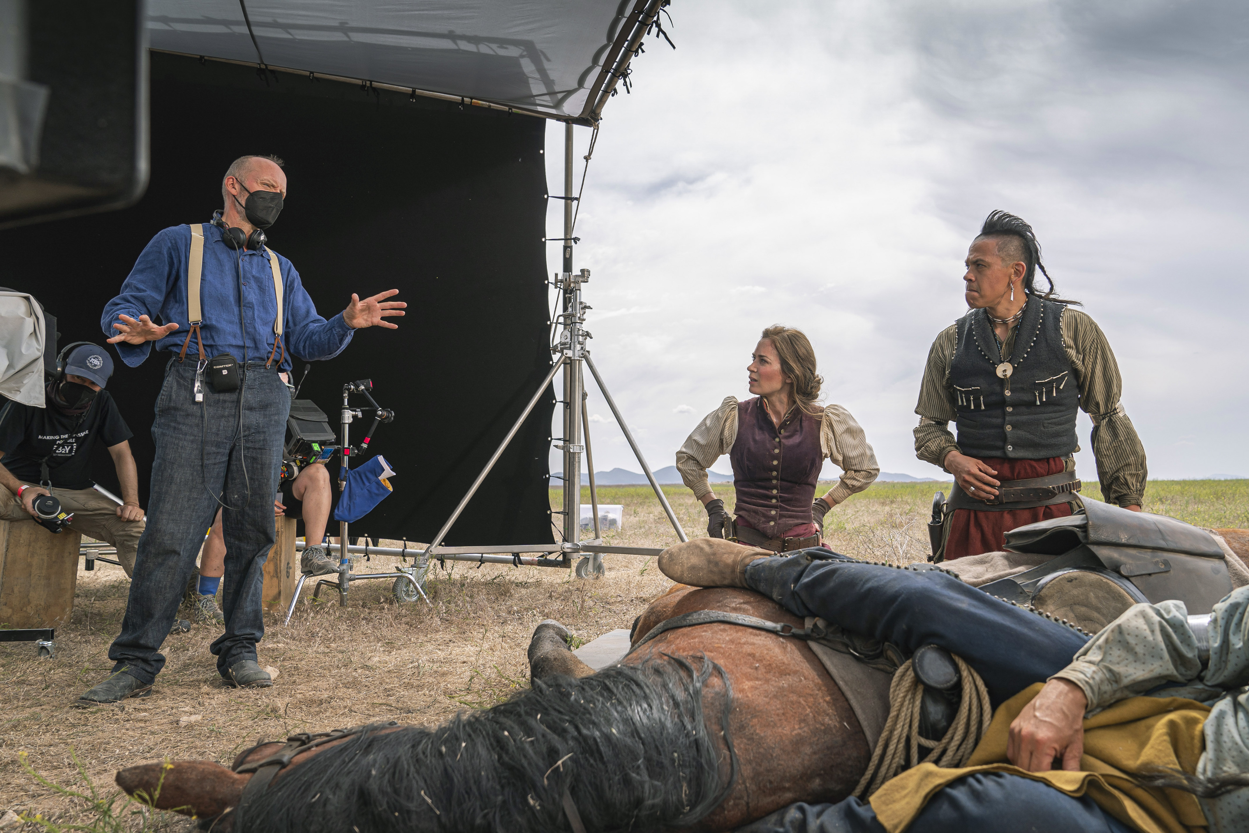 A director gives instructors to actors on a Western movie film set