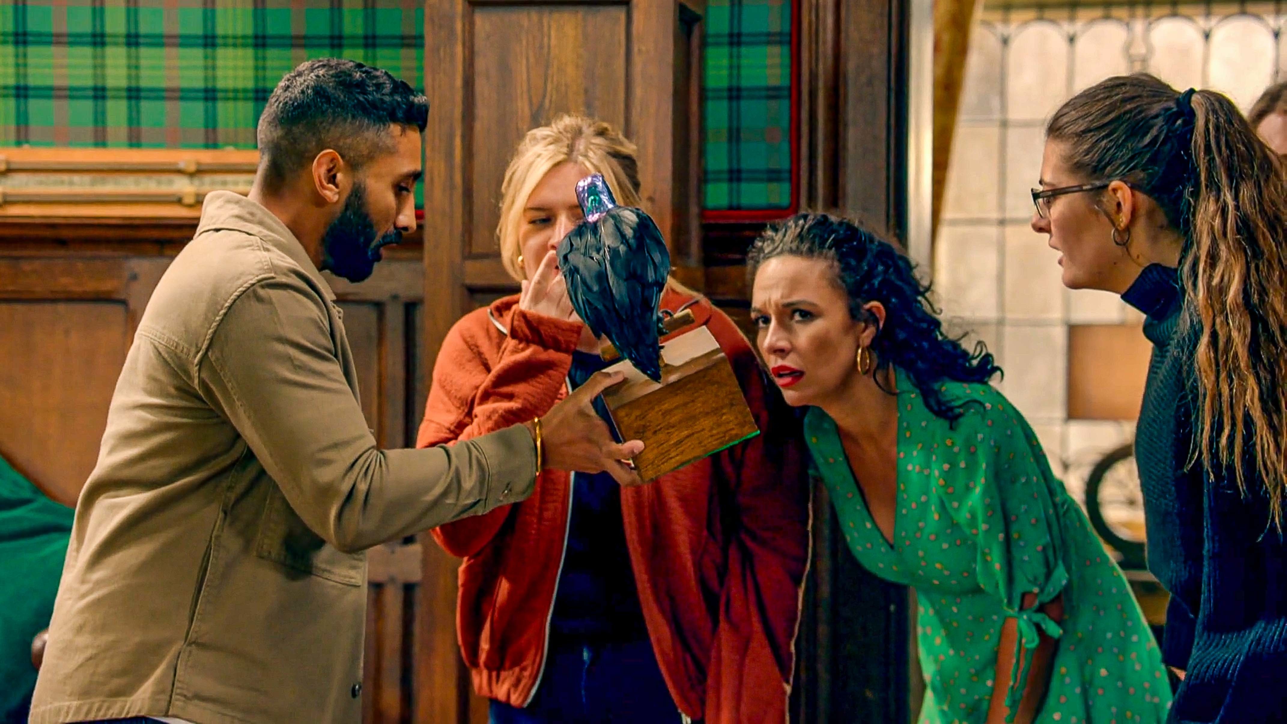 Four people scrutinising a box