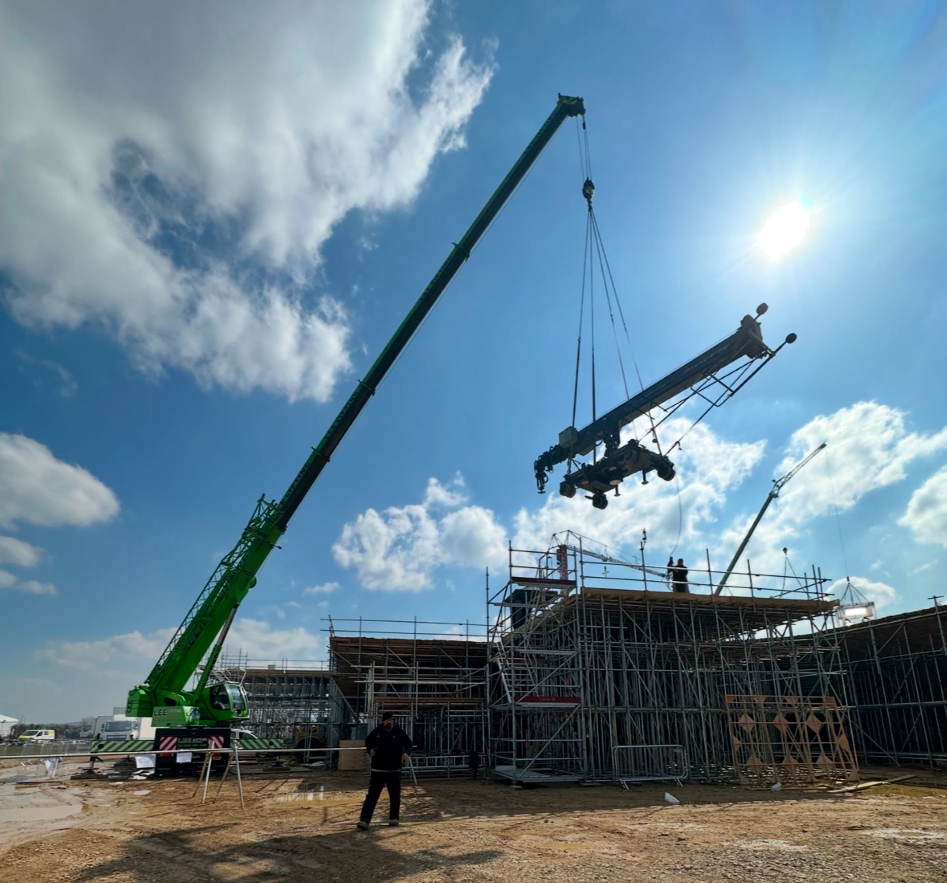 A large crane operates on a construction site