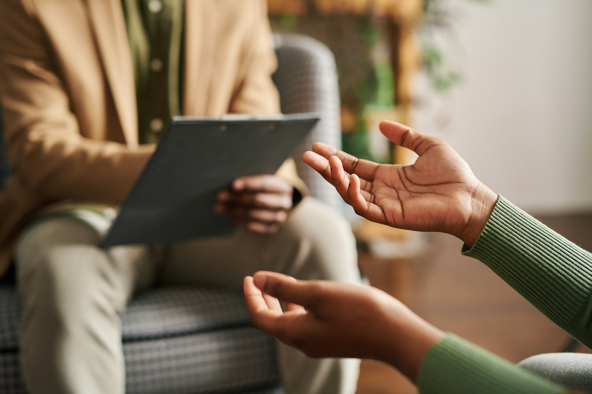 Two people sit together in a counselling session